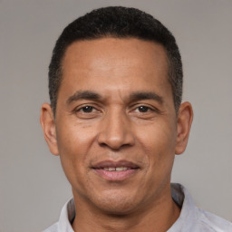 Joyful latino adult male with short  black hair and brown eyes