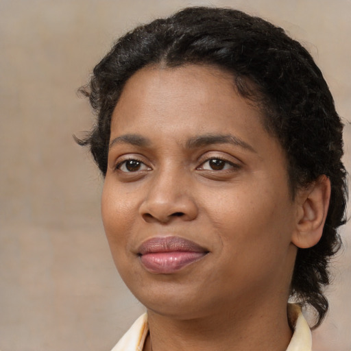 Joyful black young-adult female with medium  brown hair and brown eyes