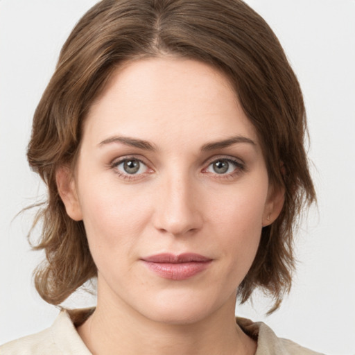 Joyful white young-adult female with medium  brown hair and green eyes