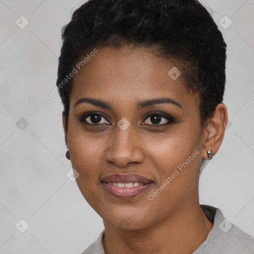 Joyful black young-adult female with short  black hair and brown eyes