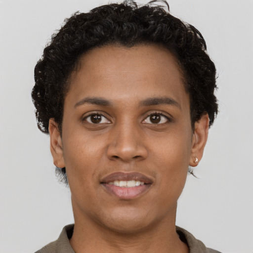 Joyful black young-adult female with short  brown hair and brown eyes