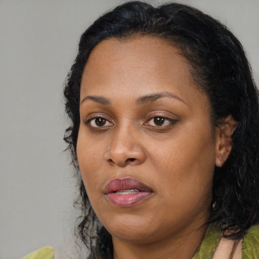 Joyful black adult female with medium  black hair and brown eyes