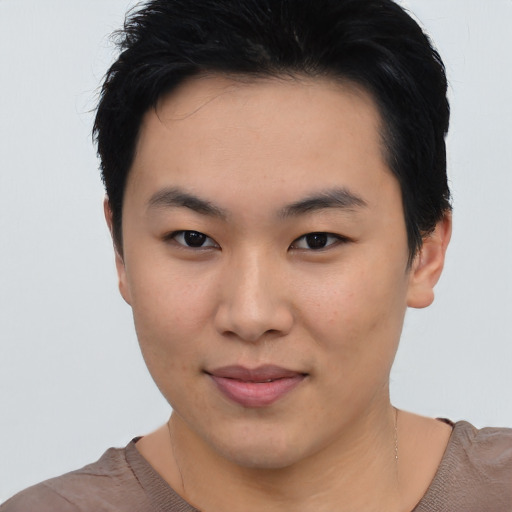Joyful asian young-adult female with short  black hair and brown eyes