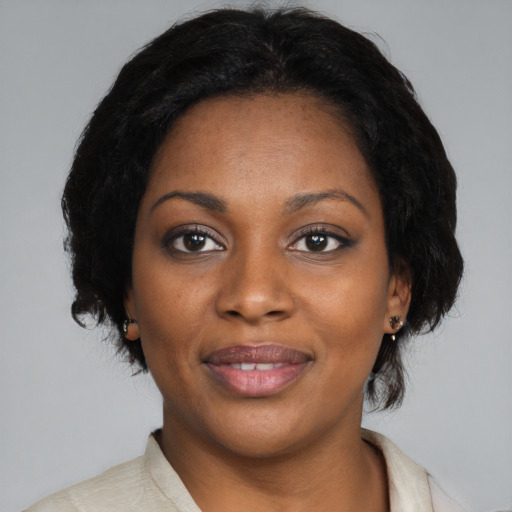 Joyful black young-adult female with medium  black hair and brown eyes