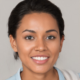 Joyful latino young-adult female with short  brown hair and brown eyes