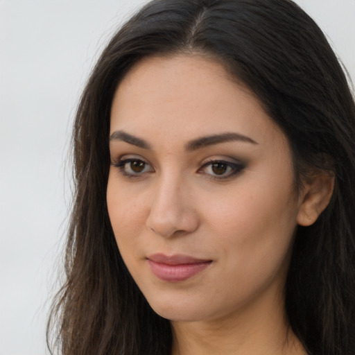 Joyful latino young-adult female with long  brown hair and brown eyes