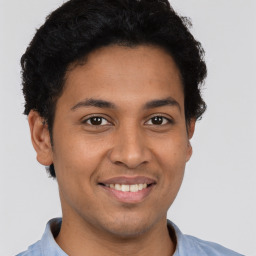 Joyful latino young-adult male with short  brown hair and brown eyes