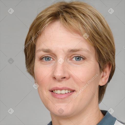 Joyful white adult female with medium  brown hair and blue eyes