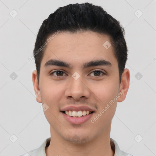 Joyful latino young-adult male with short  brown hair and brown eyes