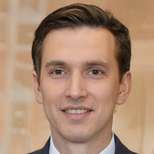 Joyful white young-adult male with short  brown hair and brown eyes