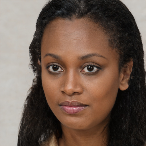 Neutral black young-adult female with long  brown hair and brown eyes