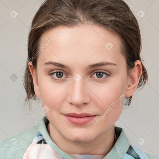 Joyful white young-adult female with medium  brown hair and blue eyes