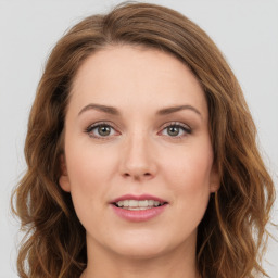 Joyful white young-adult female with long  brown hair and green eyes