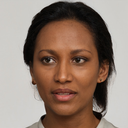 Joyful black adult female with medium  black hair and brown eyes