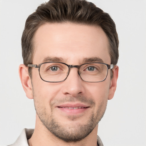 Joyful white adult male with short  brown hair and grey eyes