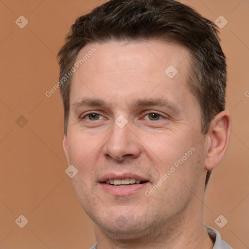 Joyful white adult male with short  brown hair and brown eyes