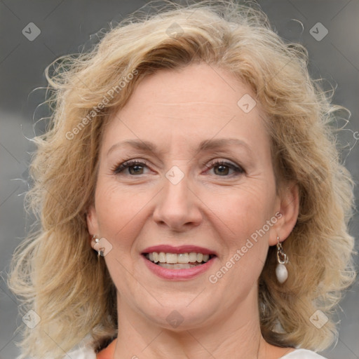 Joyful white adult female with medium  brown hair and blue eyes