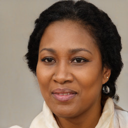 Joyful black adult female with medium  brown hair and brown eyes