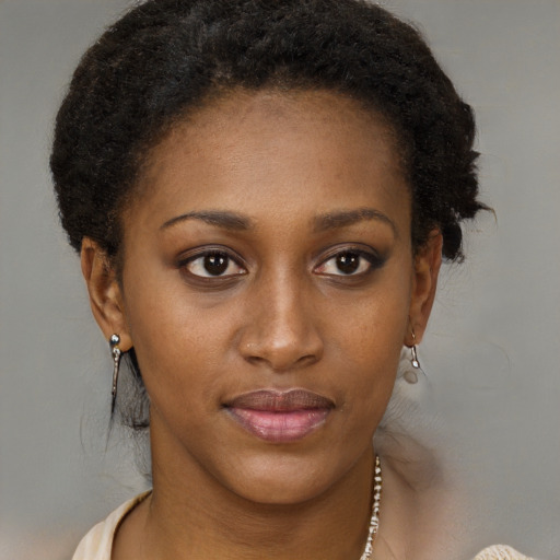 Joyful black young-adult female with short  brown hair and brown eyes