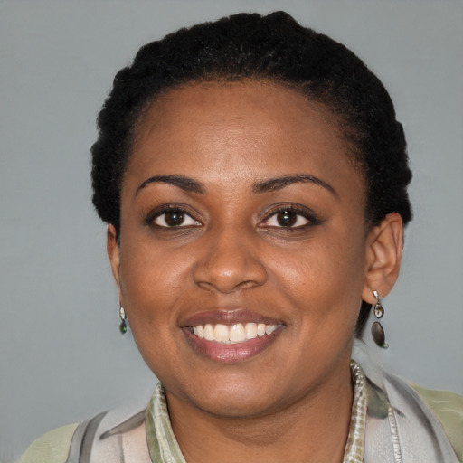 Joyful black adult female with short  black hair and brown eyes