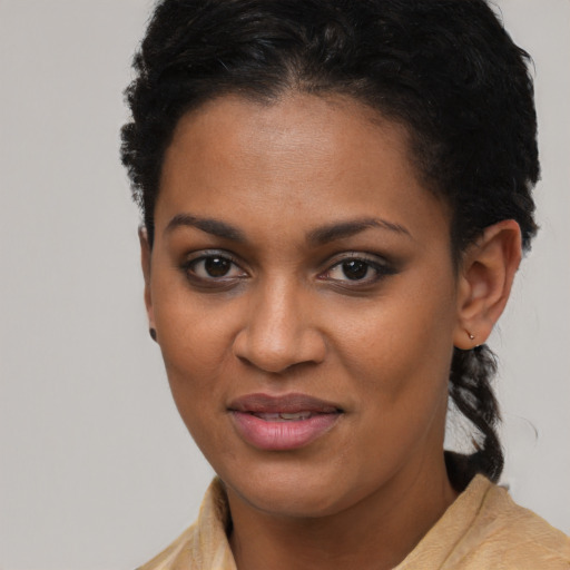Joyful black young-adult female with short  brown hair and brown eyes