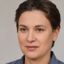 Joyful white adult female with medium  brown hair and brown eyes