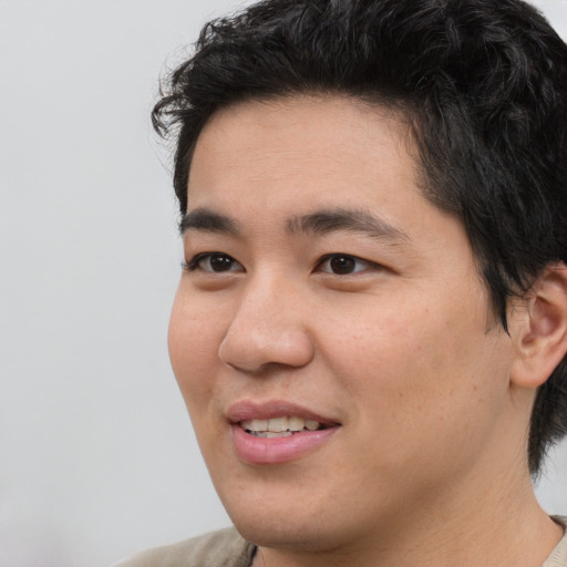 Joyful white young-adult male with medium  black hair and brown eyes
