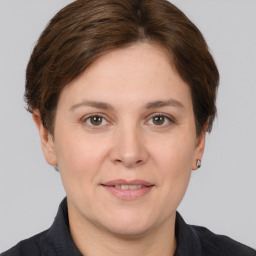 Joyful white adult female with short  brown hair and brown eyes