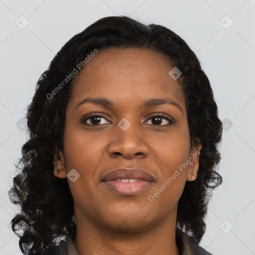 Joyful black young-adult female with long  brown hair and brown eyes
