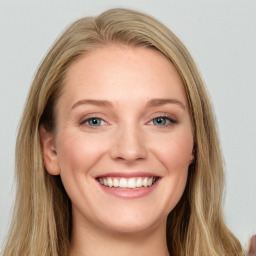 Joyful white young-adult female with long  brown hair and blue eyes