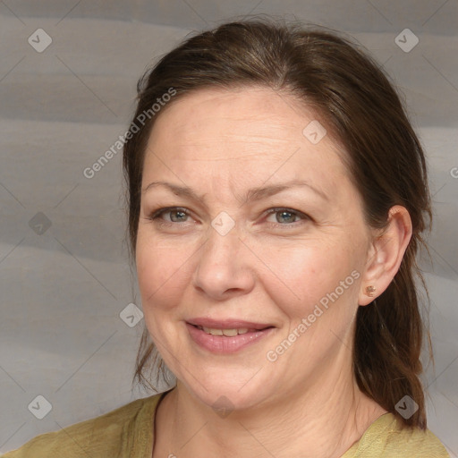 Joyful white adult female with medium  brown hair and brown eyes