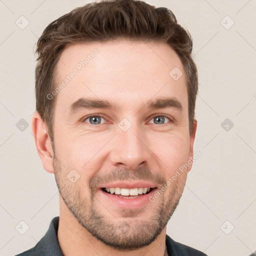 Joyful white young-adult male with short  brown hair and grey eyes