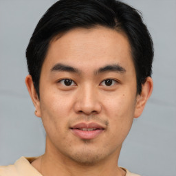 Joyful asian young-adult male with short  brown hair and brown eyes