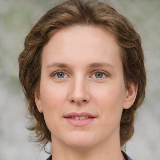 Joyful white young-adult female with medium  brown hair and green eyes