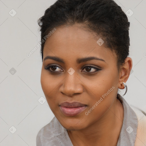 Joyful black young-adult female with short  black hair and brown eyes