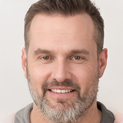 Joyful white adult male with short  brown hair and brown eyes