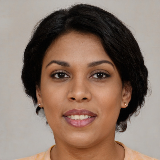 Joyful latino young-adult female with medium  black hair and brown eyes