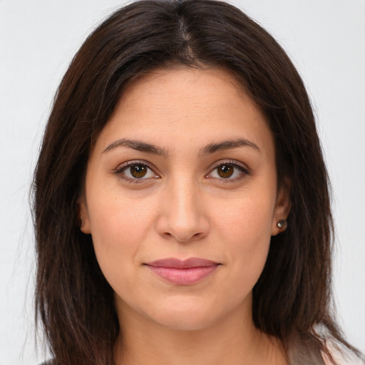 Joyful white young-adult female with long  brown hair and brown eyes