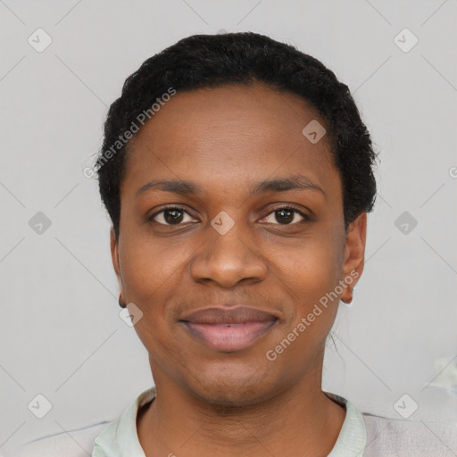 Joyful black young-adult female with short  black hair and brown eyes