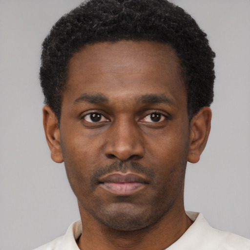 Neutral black young-adult male with short  black hair and brown eyes