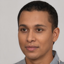 Joyful latino young-adult male with short  black hair and brown eyes