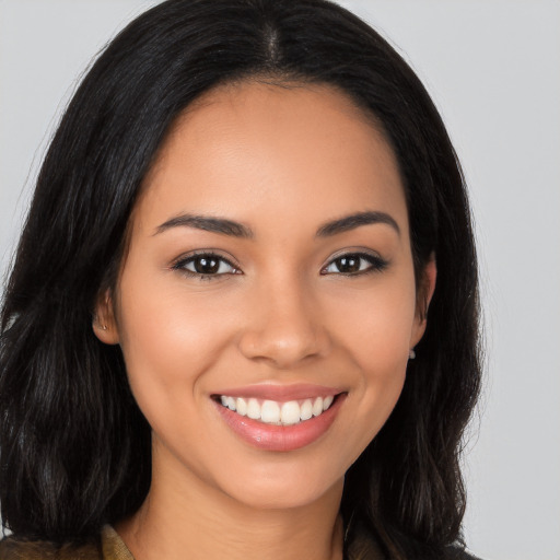 Joyful latino young-adult female with long  brown hair and brown eyes