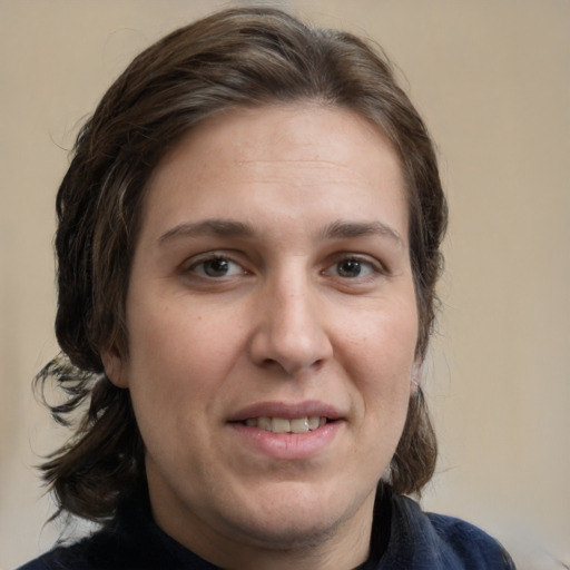 Joyful white adult female with medium  brown hair and brown eyes