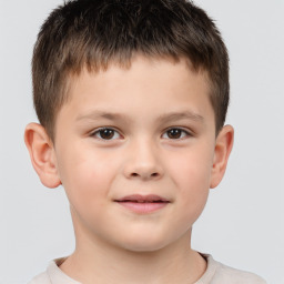 Joyful white child male with short  brown hair and brown eyes