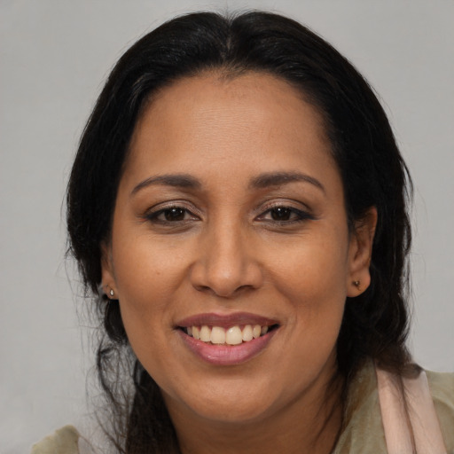 Joyful black adult female with medium  black hair and brown eyes