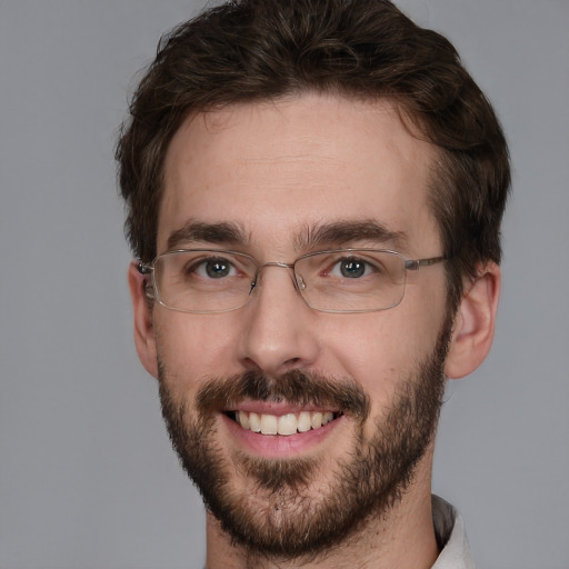 Joyful white adult male with short  brown hair and brown eyes