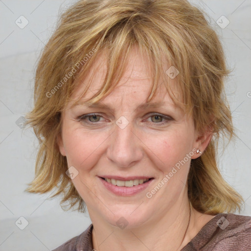 Joyful white adult female with medium  brown hair and blue eyes