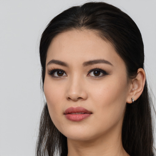 Joyful asian young-adult female with long  black hair and brown eyes