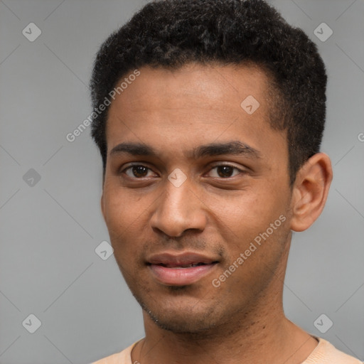 Joyful black young-adult male with short  black hair and brown eyes