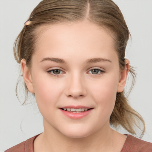 Joyful white child female with medium  brown hair and grey eyes